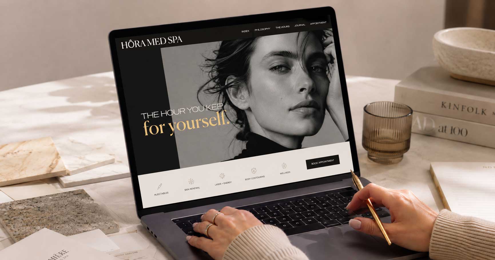 Medical spa web designer reviewing website on laptop